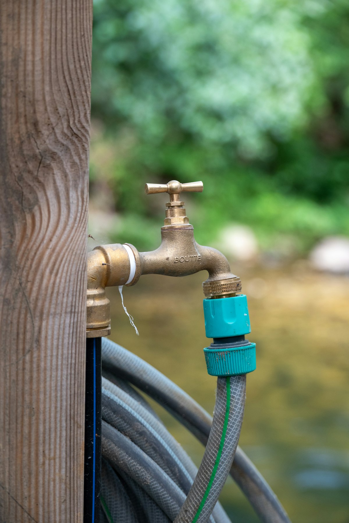 A hose connector attached to a brass outdoor tap